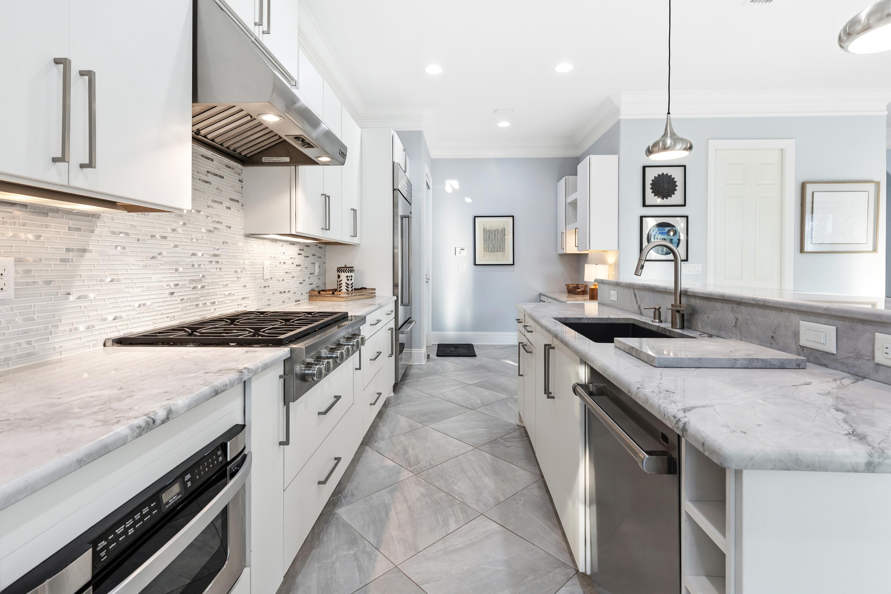 265 Rue Martine Miramar Beach, FL 32550 - Photo 15 of 82 a kitchen with stainless steel appliances granite countertop a sink stove and cabinets