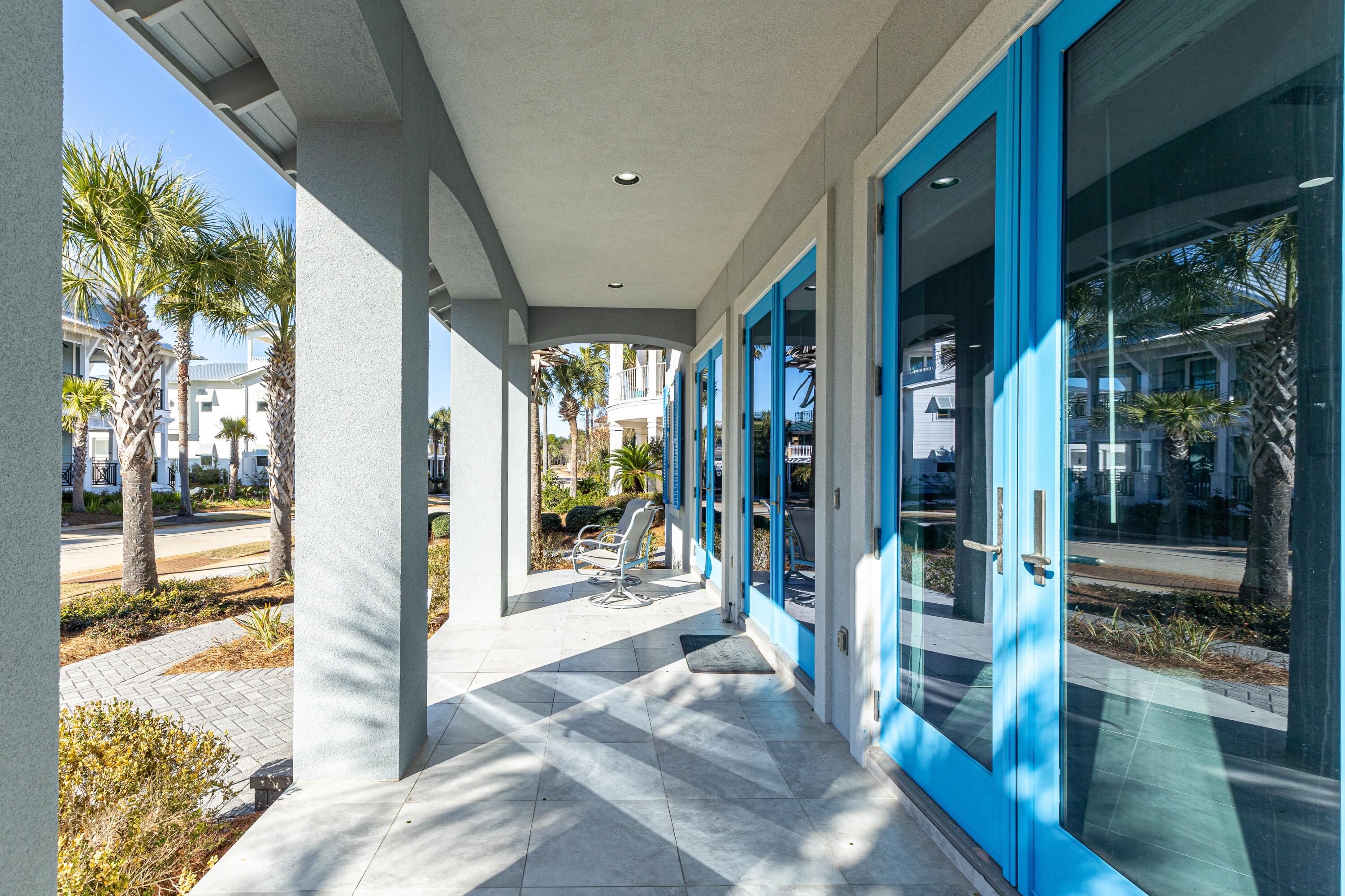 265 Rue Martine Miramar Beach, FL 32550 - Photo 6 of 82 a view of a porch with a table and chairs