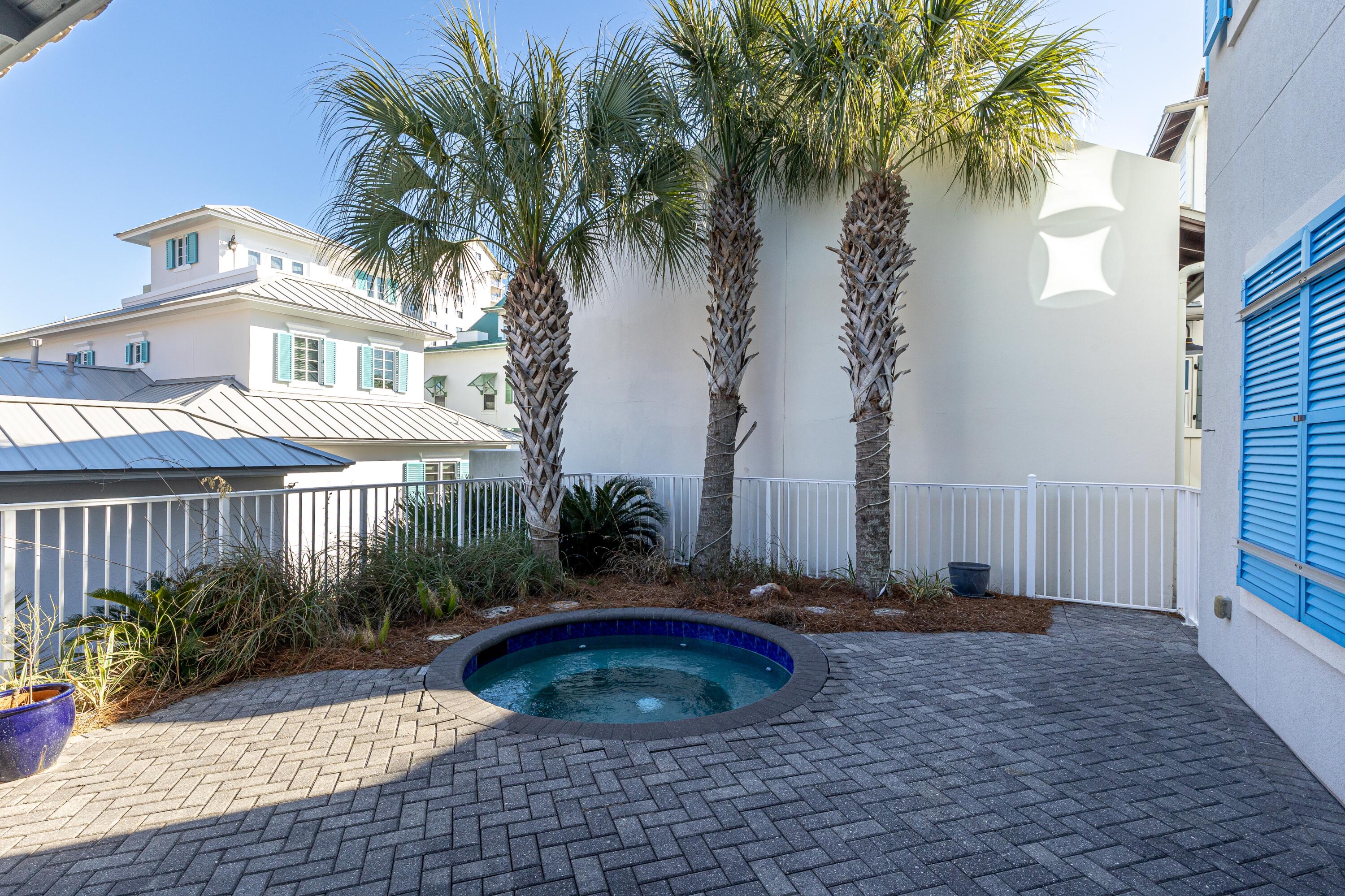265 Rue Martine Miramar Beach, FL 32550 - Photo 77 of 82 a view of a backyard with plants and palm tree