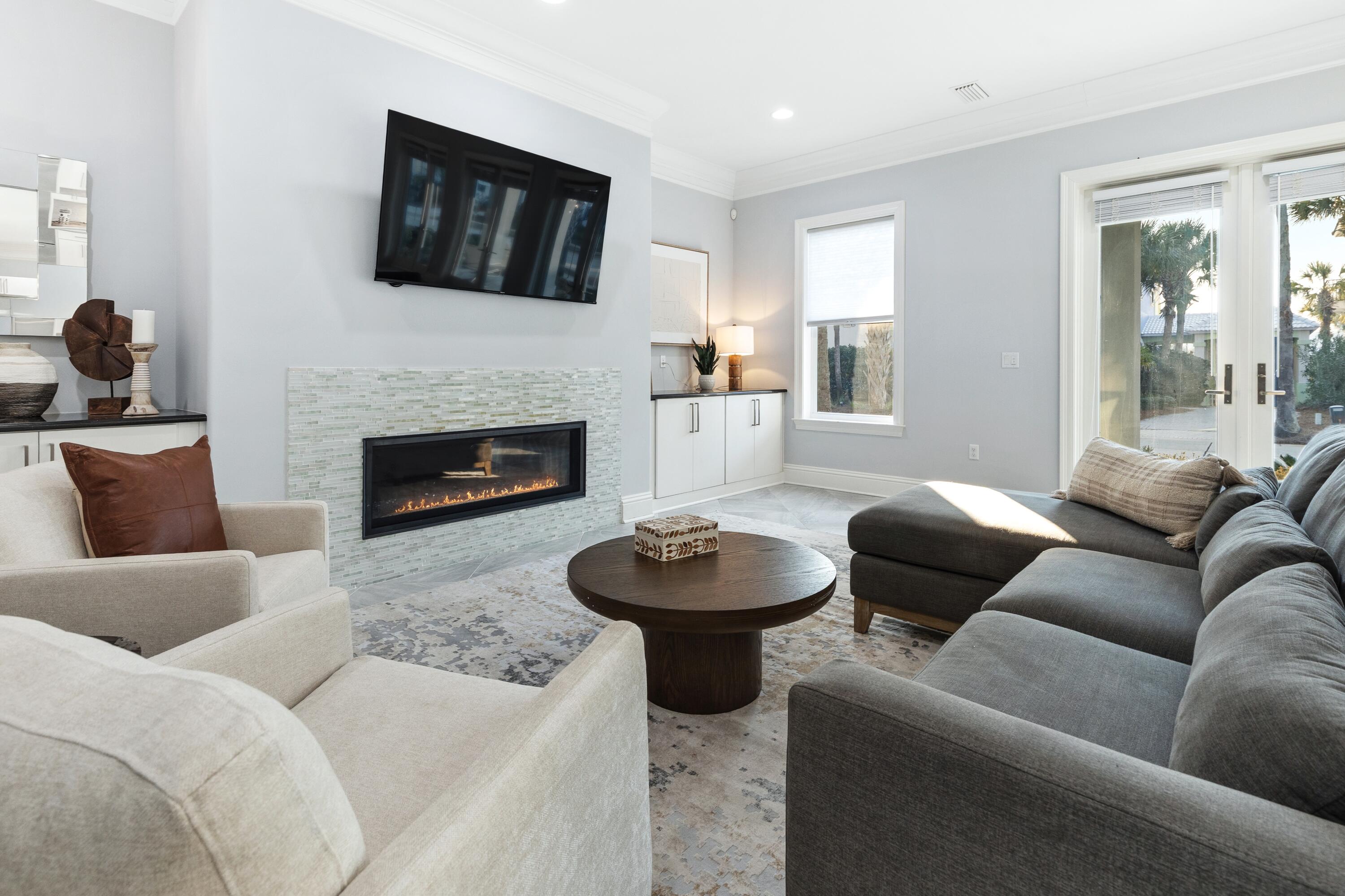 265 Rue Martine Miramar Beach, FL 32550 - Photo 9 of 82 a living room with furniture a flat screen tv and a fireplace