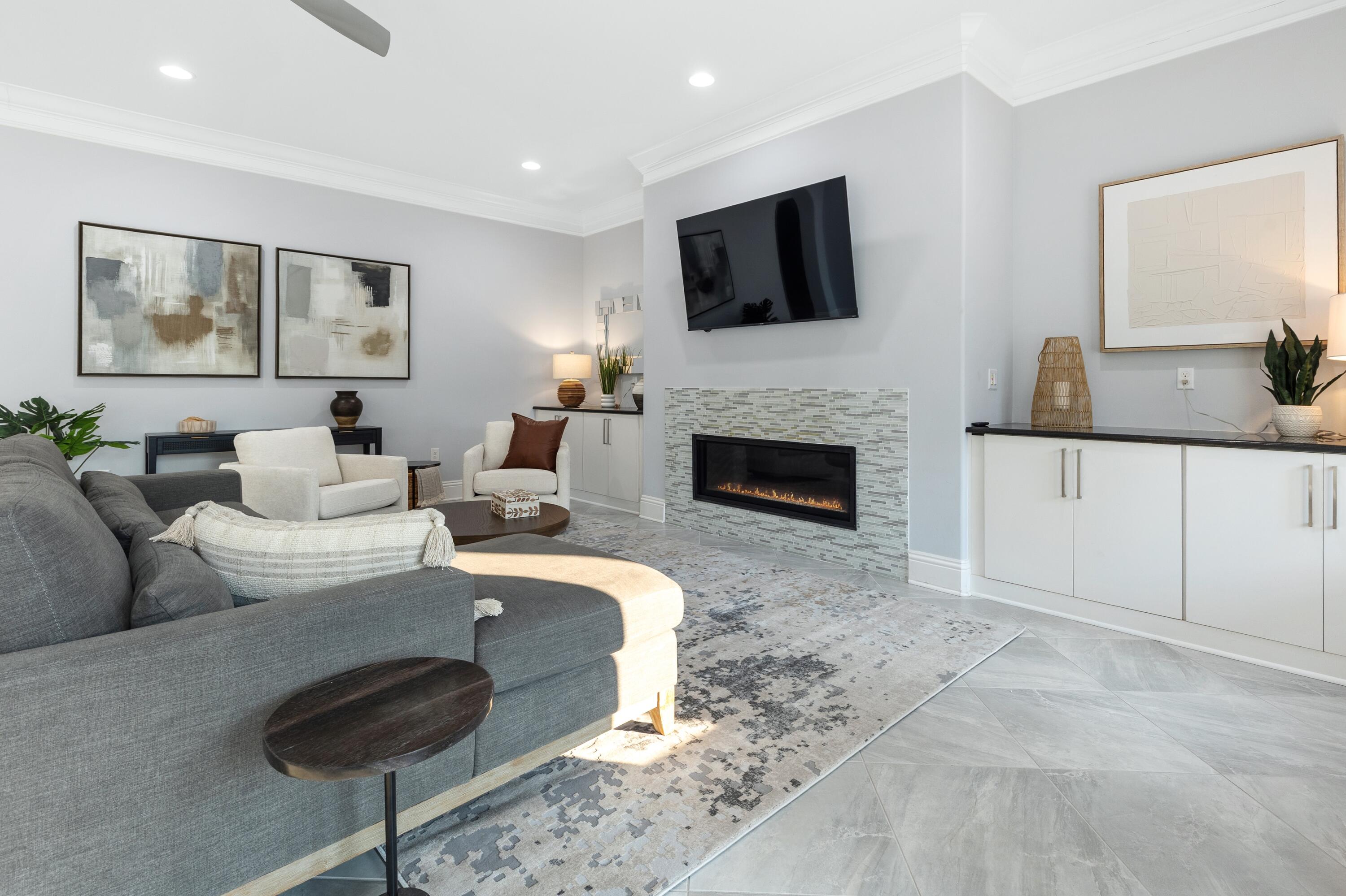 265 Rue Martine Miramar Beach, FL 32550 - Photo 10 of 82 a living room with furniture a fireplace and a flat screen tv