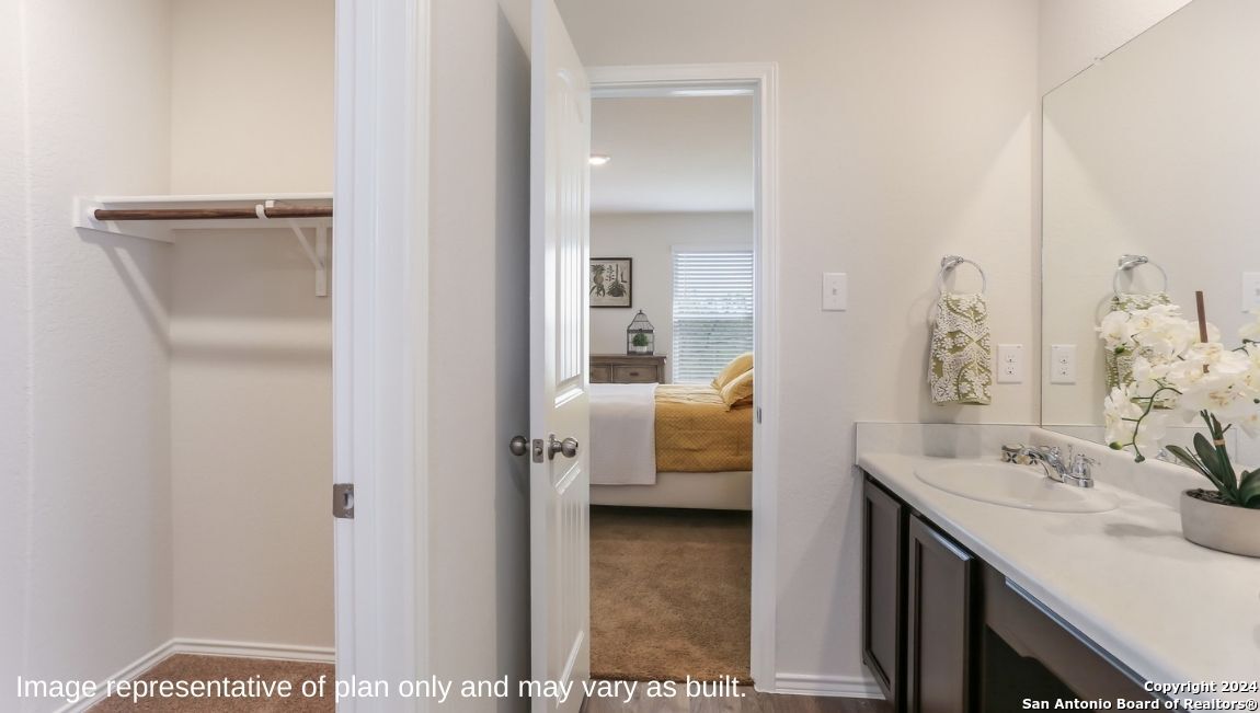 14782 Clay Rdg Run San Antonio, TX 78253 - Photo 16 of 68 a en suite bathroom with a sink and a mirror