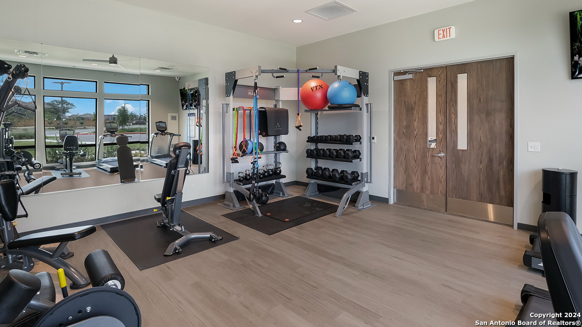 14782 Clay Rdg Run San Antonio, TX 78253 - Photo 35 of 68 a room with gym equipment and a flat screen tv
