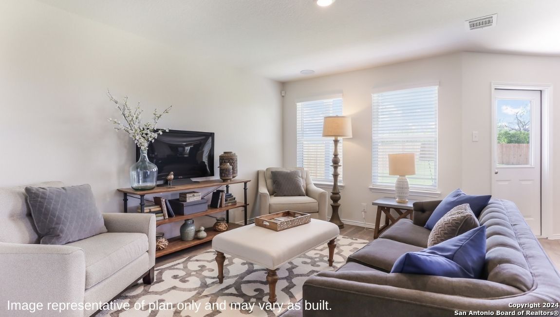14782 Clay Rdg Run San Antonio, TX 78253 - Photo 4 of 68 a living room with furniture a flat screen tv and a large window