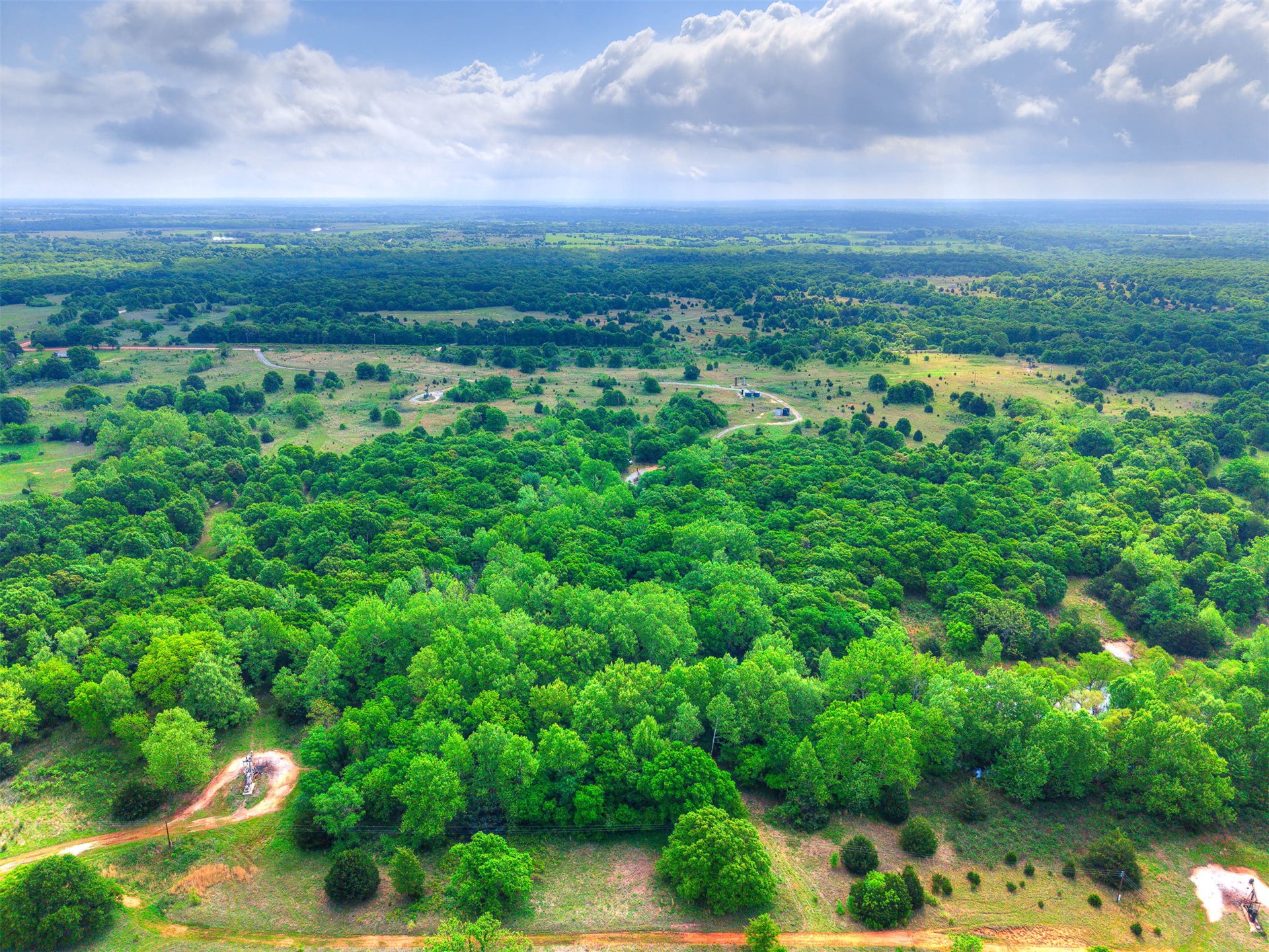 3 Patterson Road Wanette, OK 74878 - Photo 6 of 8 Expansive natural landscape featuring lush green trees, open fields, and distant bodies of water