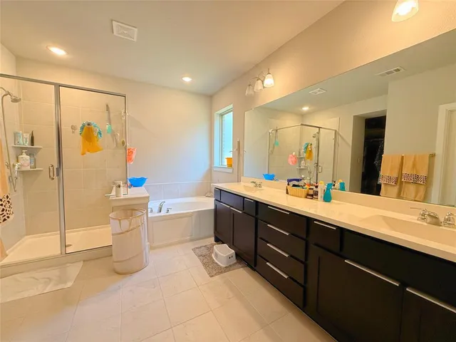 a bedroom with a bed a couch and a window