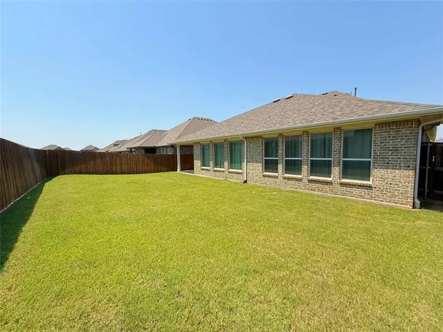 a front view of a house with a big yard