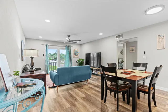 a living room with furniture a large window and a table