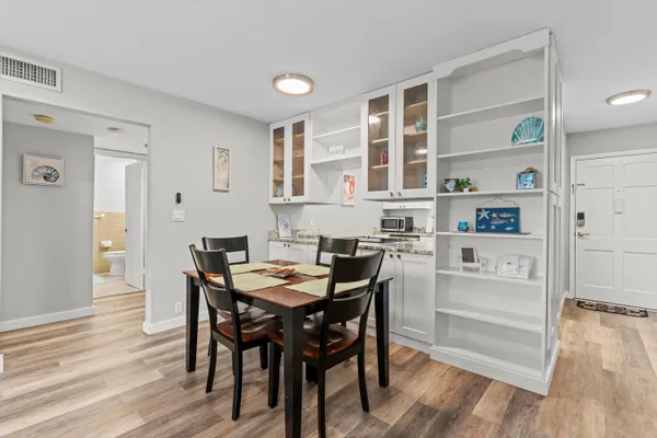 a view of a dining room with furniture and wooden floor