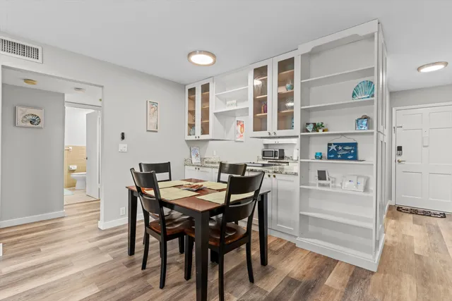 a view of a dining room with furniture and wooden floor