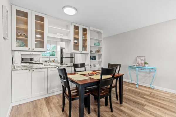 a view of a dining room with furniture and wooden floor