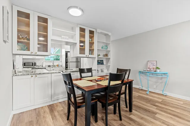 a view of a dining room with furniture and wooden floor