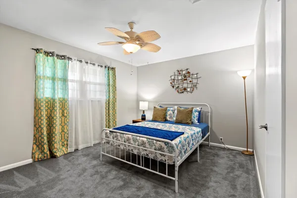 a bedroom with a bed and a chandelier