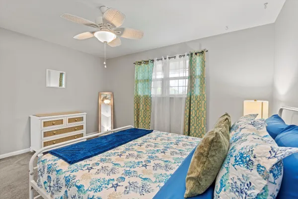 a bedroom with a large bed and a chandelier