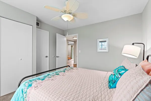 a bedroom with a bed dresser and a window