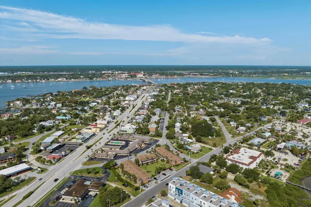 an aerial view of residential building and ocean