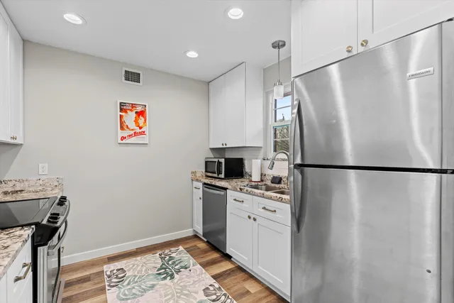 a kitchen with stainless steel appliances a refrigerator and a stove top oven