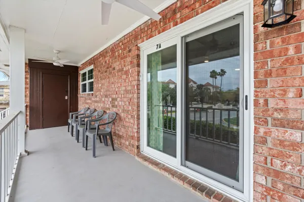 a balcony with furniture and a gate