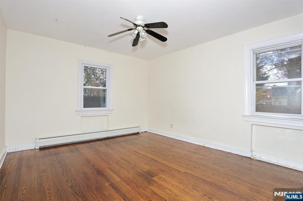 325 New Bridge Road Bergenfield, NJ 07621 - Photo 13 of 50 wooden floor in an empty room with a window