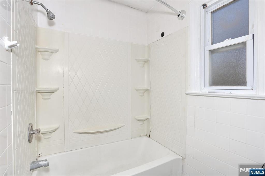 325 New Bridge Road Bergenfield, NJ 07621 - Photo 16 of 50 a bathroom with a white bath tub