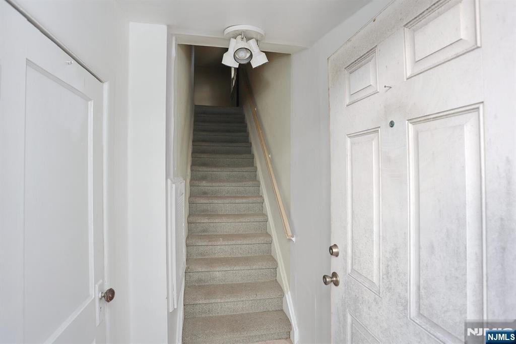 325 New Bridge Road Bergenfield, NJ 07621 - Photo 19 of 50 a view of a hallway with wooden floor and staircase
