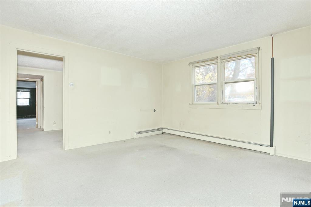 325 New Bridge Road Bergenfield, NJ 07621 - Photo 22 of 50 an empty room with a empty space and windows