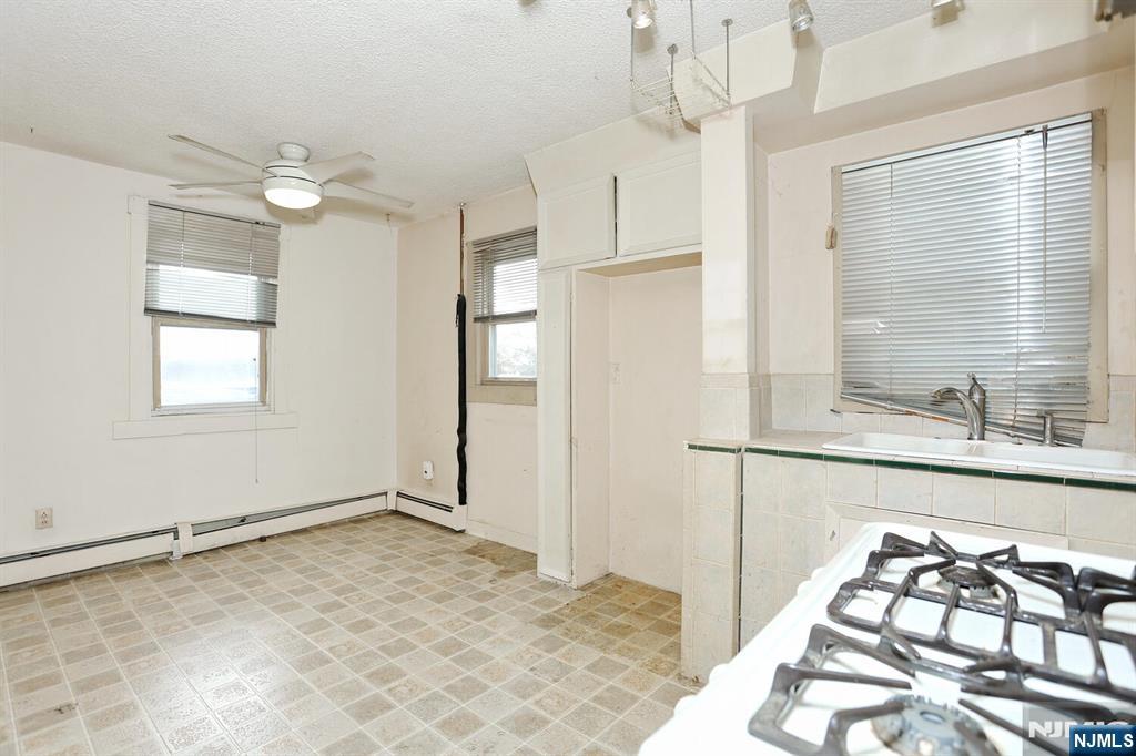 325 New Bridge Road Bergenfield, NJ 07621 - Photo 23 of 50 a view of a kitchen with a sink and cabinet area