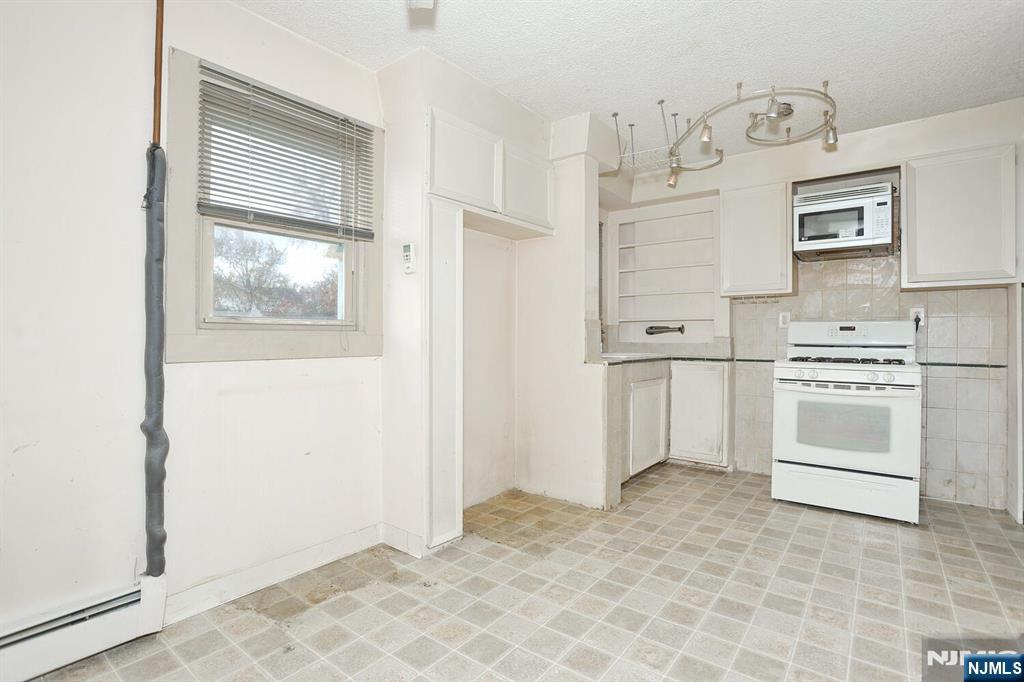 325 New Bridge Road Bergenfield, NJ 07621 - Photo 24 of 50 a view of kitchen with cabinets and window