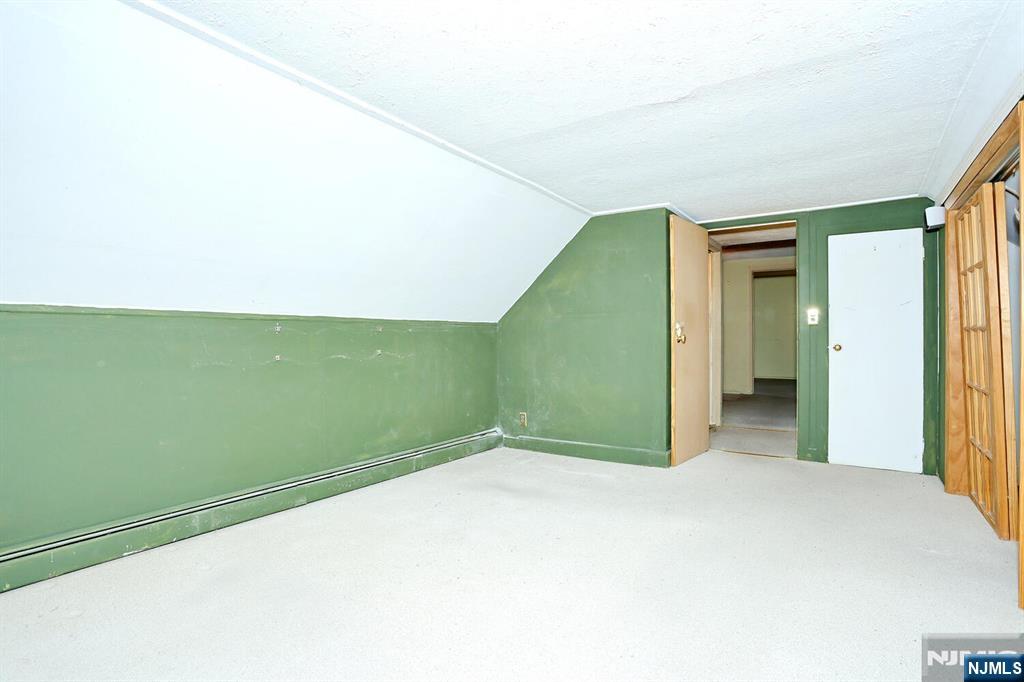 325 New Bridge Road Bergenfield, NJ 07621 - Photo 31 of 50 a view of a big room with closet and chandelier fan