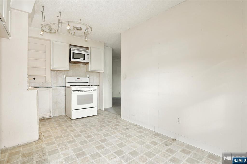 325 New Bridge Road Bergenfield, NJ 07621 - Photo 35 of 50 a view of kitchen and white cabinets