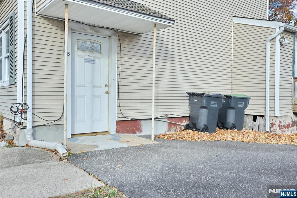325 New Bridge Road Bergenfield, NJ 07621 - Photo 36 of 50 a view of a house with a patio and a yard