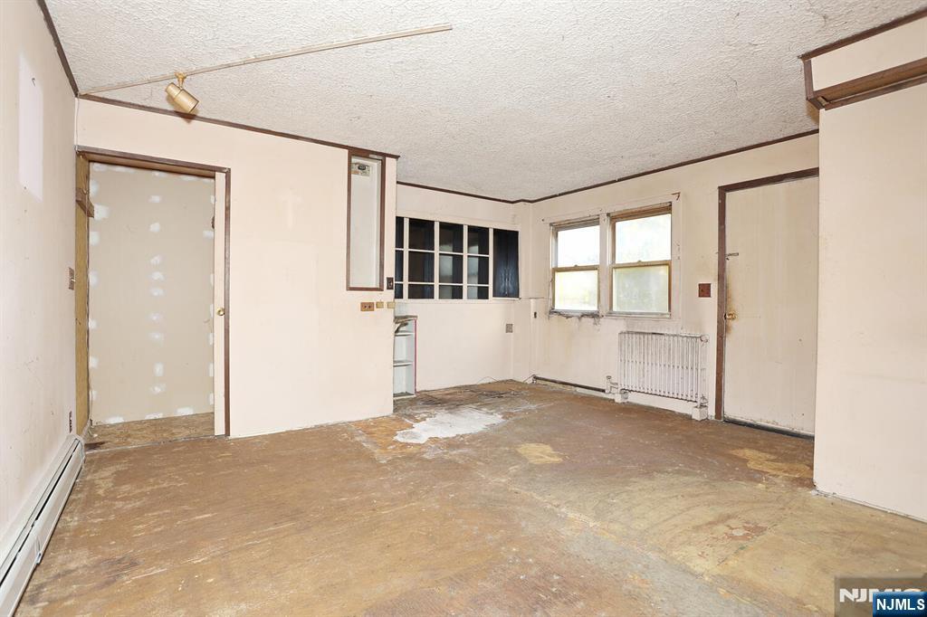 325 New Bridge Road Bergenfield, NJ 07621 - Photo 39 of 50 an empty room with windows