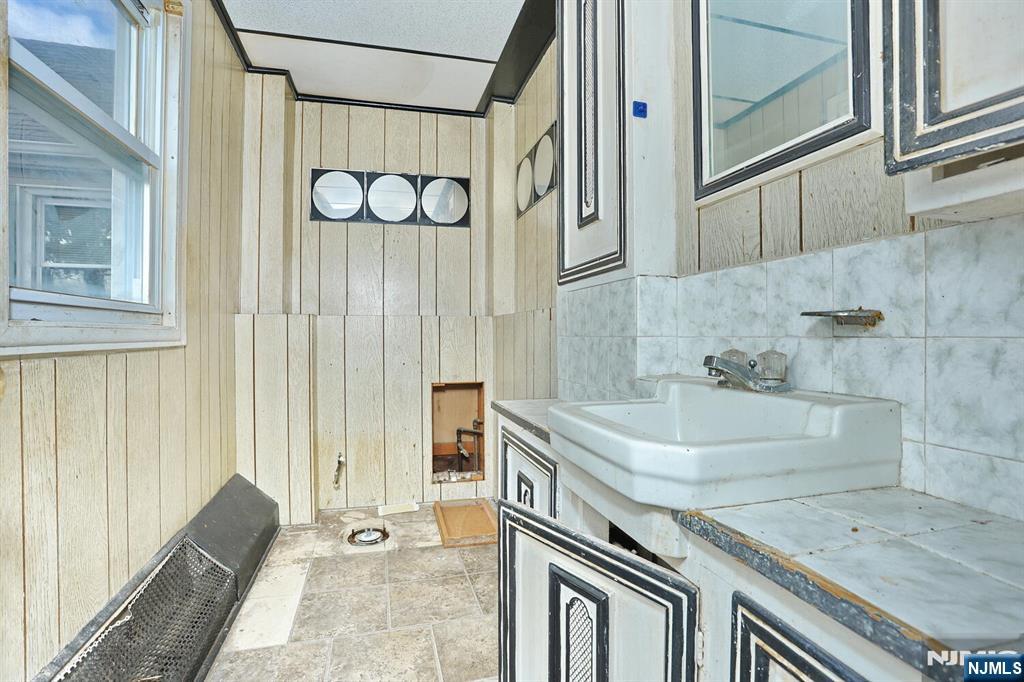 325 New Bridge Road Bergenfield, NJ 07621 - Photo 41 of 50 a bathroom with a granite countertop sink and a shower