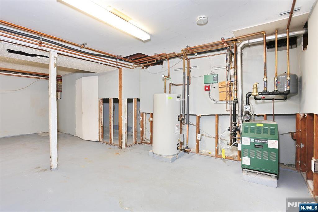 325 New Bridge Road Bergenfield, NJ 07621 - Photo 44 of 50 a view of walk in closet with clothes and shoes