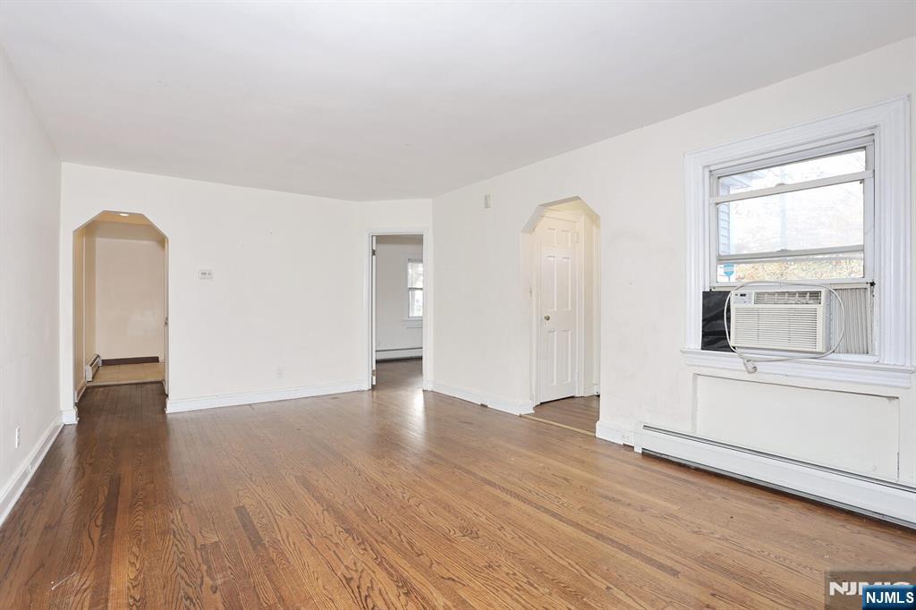 325 New Bridge Road Bergenfield, NJ 07621 - Photo 5 of 50 a view of empty room with wooden floor and fan