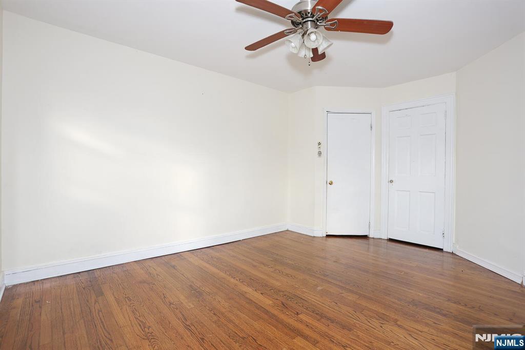 325 New Bridge Road Bergenfield, NJ 07621 - Photo 8 of 50 a view of an empty room with wooden floor