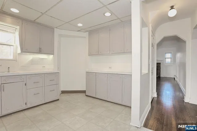 a view of a kitchen with sink and cabinet with wooden floor