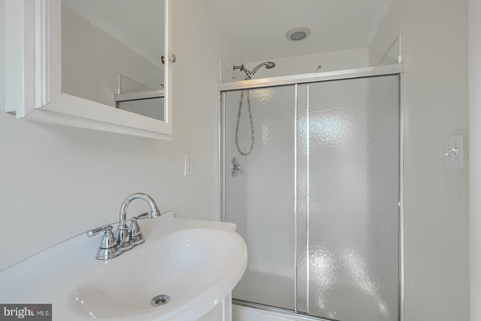 1026 Patapsco Street Baltimore, MD 21230 - Photo 15 of 24 a bathroom with a shower and a sink