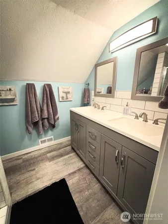 a bathroom with a sink double vanity and a mirror