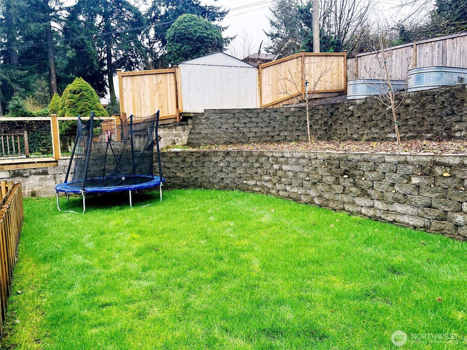 336 Harvard Avenue Fircrest, WA 98466 - Photo 3 of 17 a view of a backyard with wooden fence and a bench