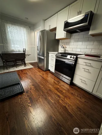 a kitchen with stainless steel appliances a stove a refrigerator and a sink