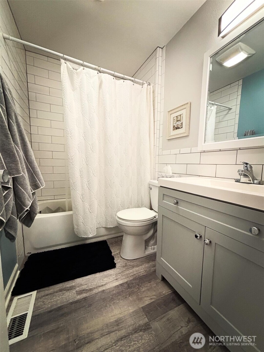 336 Harvard Avenue Fircrest, WA 98466 - Photo 8 of 17 a bathroom with a sink a toilet a window and a mirror
