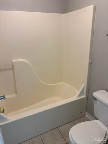 a bathroom with a toilet and bathtub