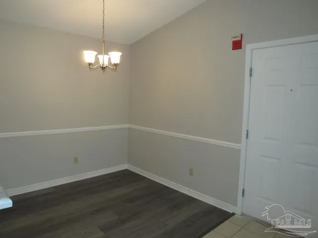 a view of a chandelier fan and wooden floor