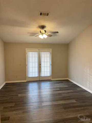 a view of room with hardwood floor and ceiling fan