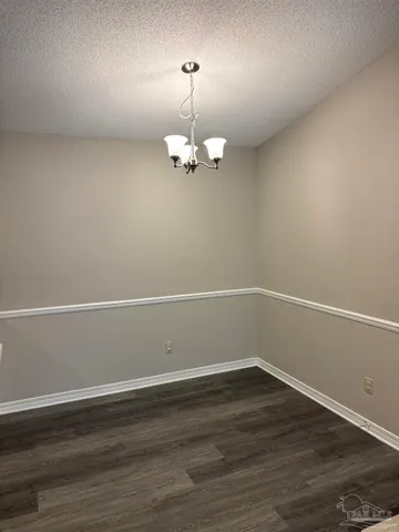 a view of a room with wooden floor and white walls