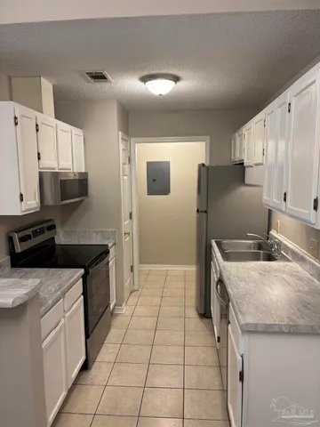 a kitchen with a sink stove and refrigerator