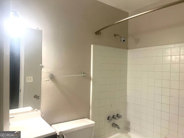 a bathroom with a shower and a toilet