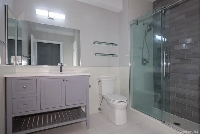 a bathroom with a double vanity sink toilet and shower
