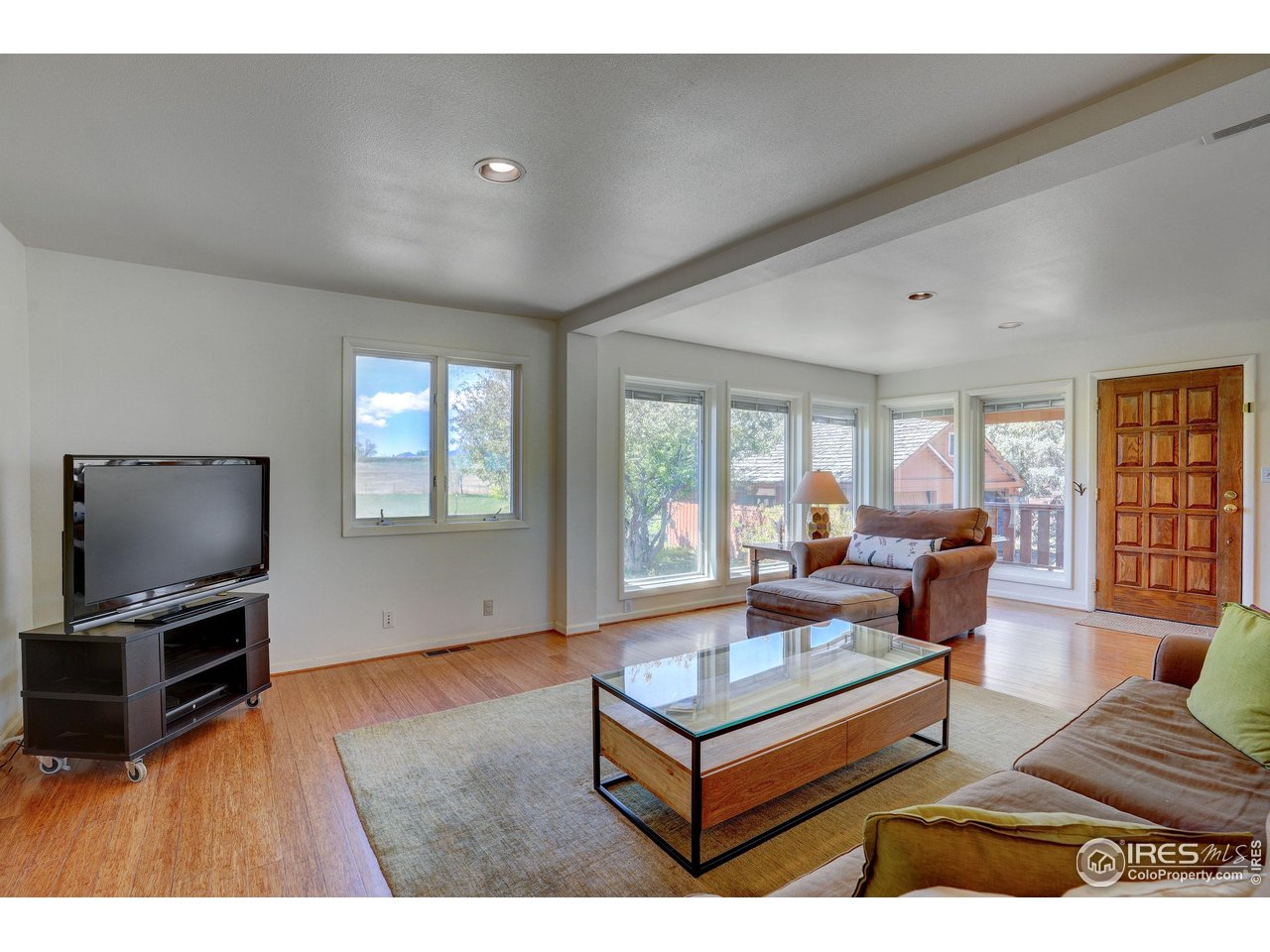 5196 Oxford Road Longmont, CO 80503 - Photo 23 of 38 a living room with furniture and a flat screen tv